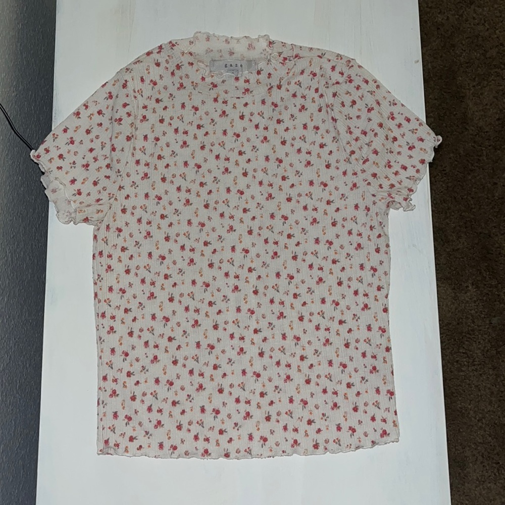 White flowery shirt in the size adult small